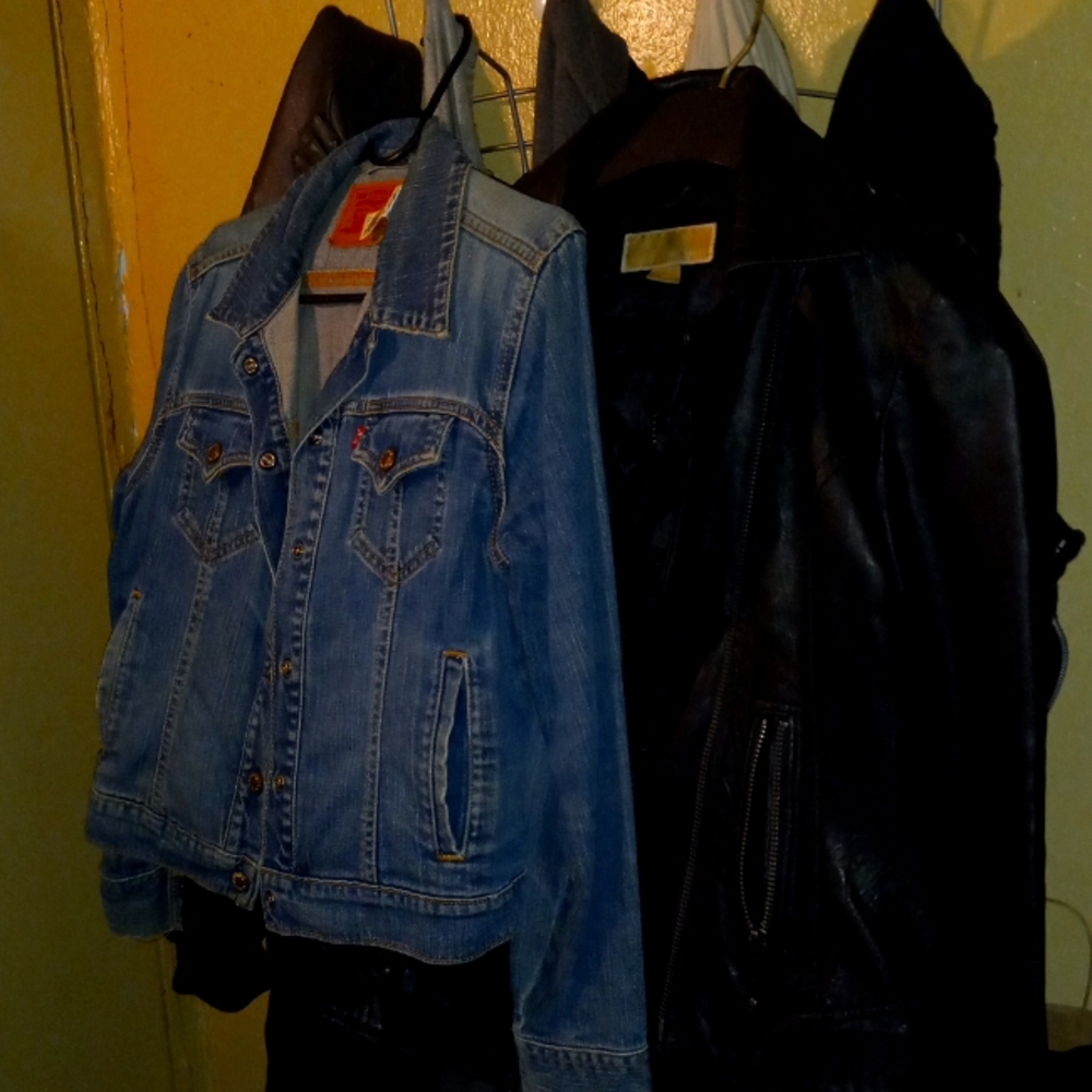 One levi jean jacket and one leather micheal kors jacket